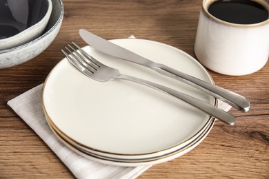 Set of clean dishware on wooden table