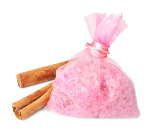 Scented sachet with aroma beads and cinnamon on white background