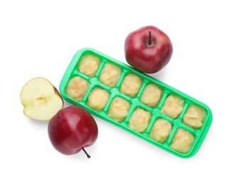 Apple puree in ice cube tray and fresh apple fruits isolated on white, top view. Ready for freezing