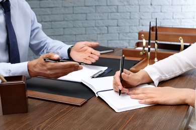 Male lawyer with client at table in office
