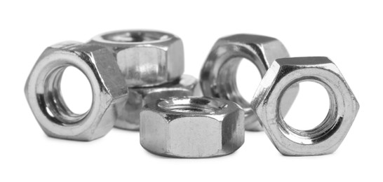Many metal hex nuts on white background