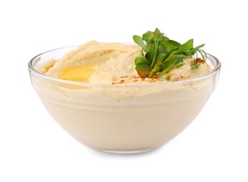 Photo of Bowl of tasty hummus with pea leaves and paprika isolated on white