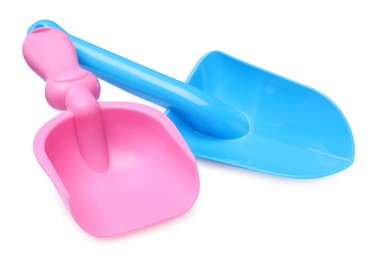 Photo of Light blue and pink plastic toy shovels on white background
