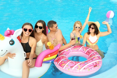 Group of happy people enjoying fun pool party