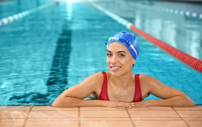 Young athletic woman in swimming pool