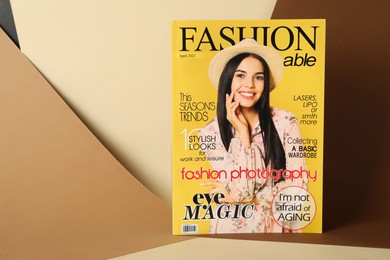 Modern printed fashion magazine on color background, space for text