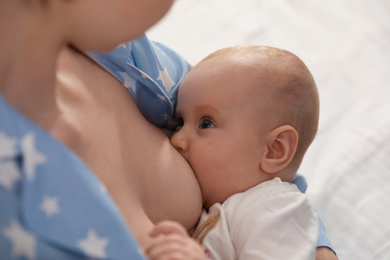 Young woman breast feeding her little baby, closeup