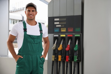 Worker in uniform at modern gas station