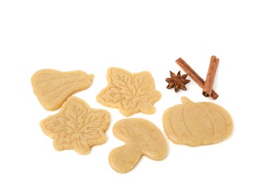 Photo of Unbaked cookies of different shapes and spices on white background