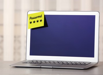 Sticky note with password on laptop indoors. Space for text