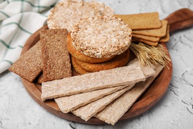 Rye crispbreads, rice cakes and rusks on white textured table