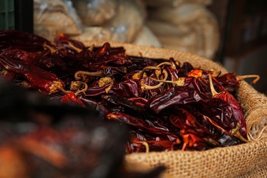 Pile of dried guajillo peppers in burlap, closeup