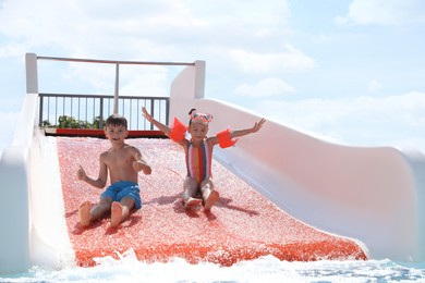 Cute little children on slide in water park