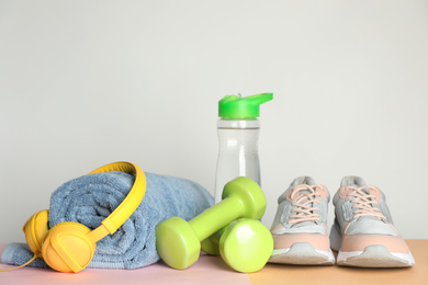Composition with fitness equipment and headphones on table