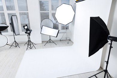 Photo of Interior of modern photo studio with professional lighting equipment