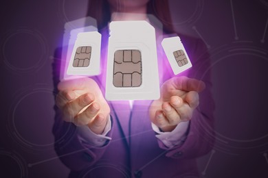 Woman demonstrating SIM cards of different sizes on color background, closeup 