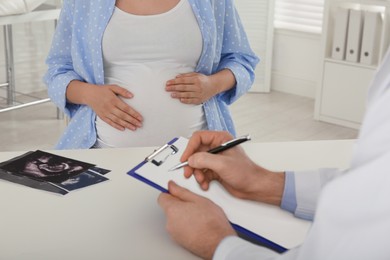Pregnant woman having appointment at gynecologist office, closeup
