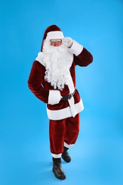 Full length portrait of Santa Claus on light blue background