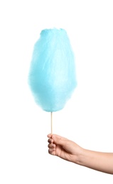 Woman holding sweet blue cotton candy on white background, closeup view