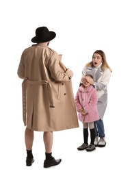 Photo of Exhibitionist exposing naked body under coat in front of mother with child isolated on white