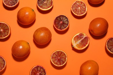Many ripe sicilian oranges on orange background, flat lay