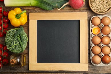 Blank chalkboard and different fresh products on wooden table, flat lay with space for text. Cooking Classes