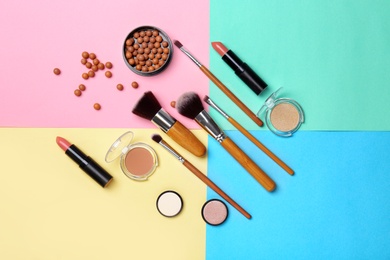 Decorative makeup products on color background