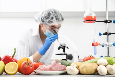 Scientist checking products at table in laboratory. Quality control
