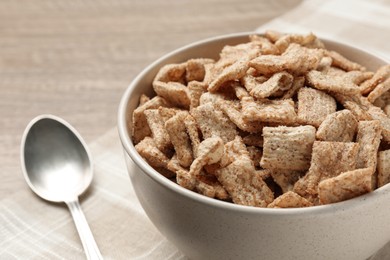 Bowl of sweet crispy breakfast cereal on table, closeup