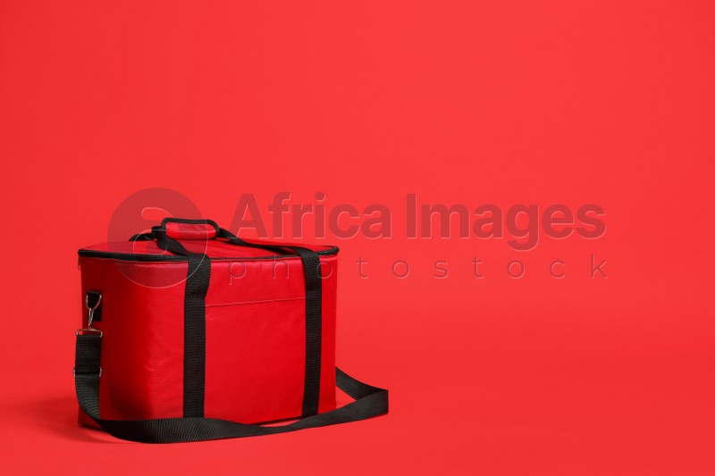 Modern large thermo bag on red background. Space for text