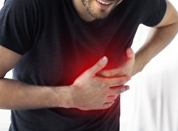Man having heart attack at home, closeup