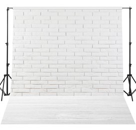 Photo background with white brick wall and wooden floor. Professional studio equipment