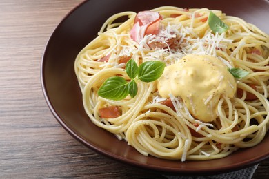 Delicious spaghetti with cheese sauce and meat on wooden table, closeup