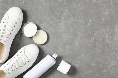 Flat lay composition with stylish footwear and shoe care accessories on grey background, space or text