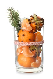 Photo of Christmas composition with tangerine pomander balls in glass isolated on white