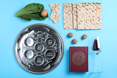 Flat lay composition with symbolic Pesach (Passover Seder) items on light blue background