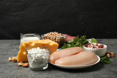 Photo of Products rich in protein on grey table