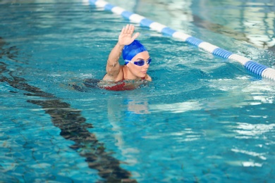 Young athletic woman swimming in pool