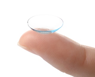 woman holding contact lens on light background, closeup