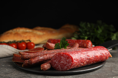 Different tasty sausages on grey table, closeup