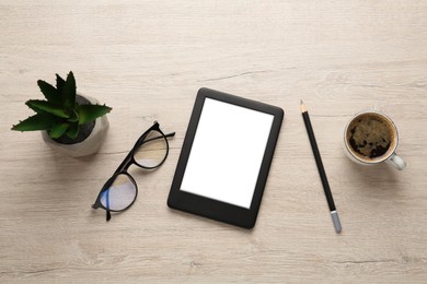 Modern e-book reader, plant, glasses and coffee on white wooden table, flat lay