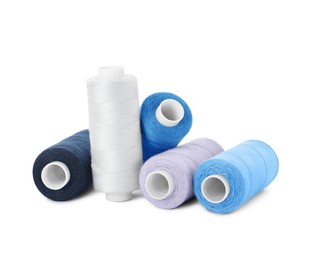 Photo of Many different colorful sewing threads on white background