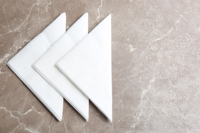 Clean napkins on marble table, flat lay. Space for text