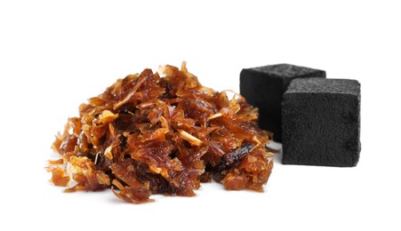 Pile of hookah tobacco and charcoal cubes on white background