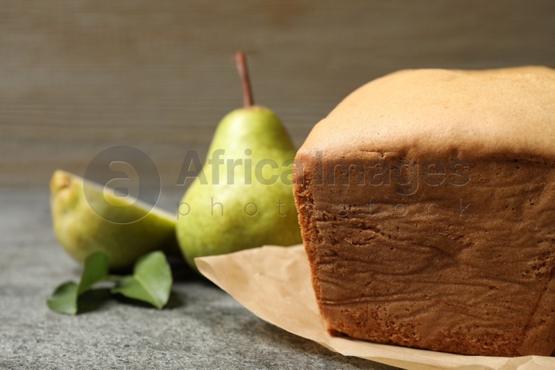 Photo of Tasty bread and pears on grey table, closeup. Homemade cake