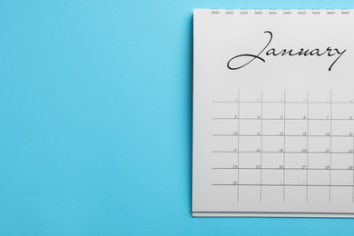 January calendar on light blue background, top view. Space for text