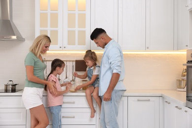 Happy family cooking together in modern kitchen