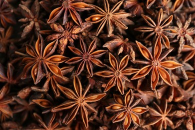 Aromatic anise stars as background, top view