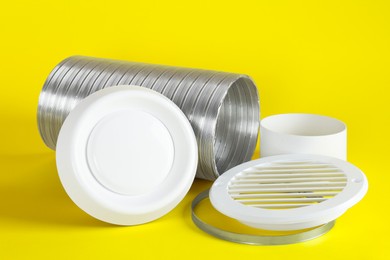 Parts of home ventilation system on yellow background