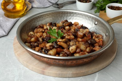 Photo of Tasty fried cracklings on light table. Cooked pork lard